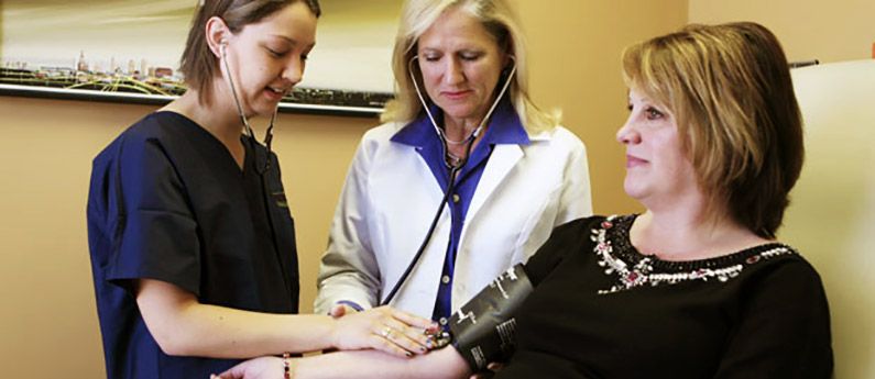 Medical / Healthcare Programs A student learning to take blood pressure through Wellspring's Medical Healthcare programs.